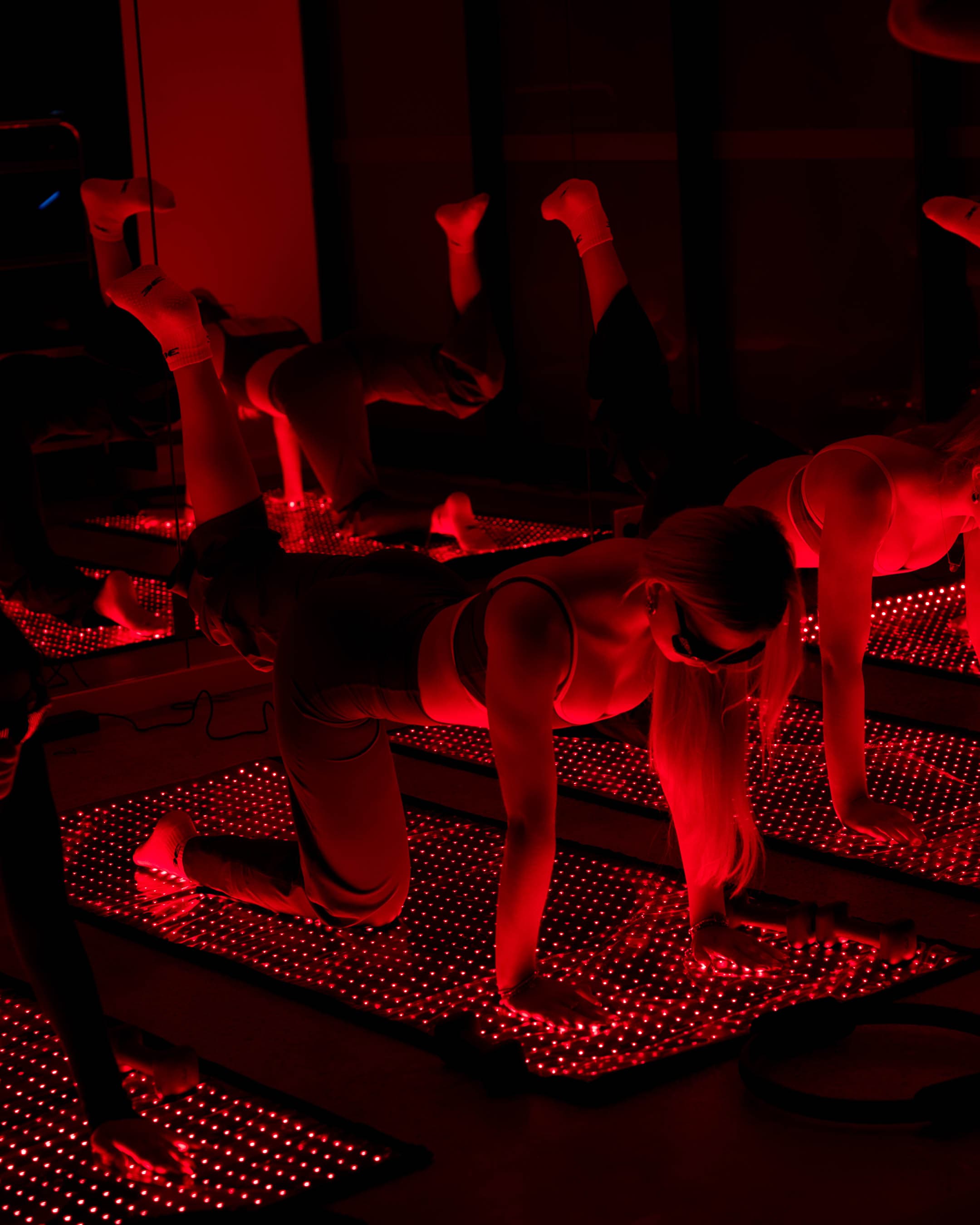 Red light Pilates class plank pose